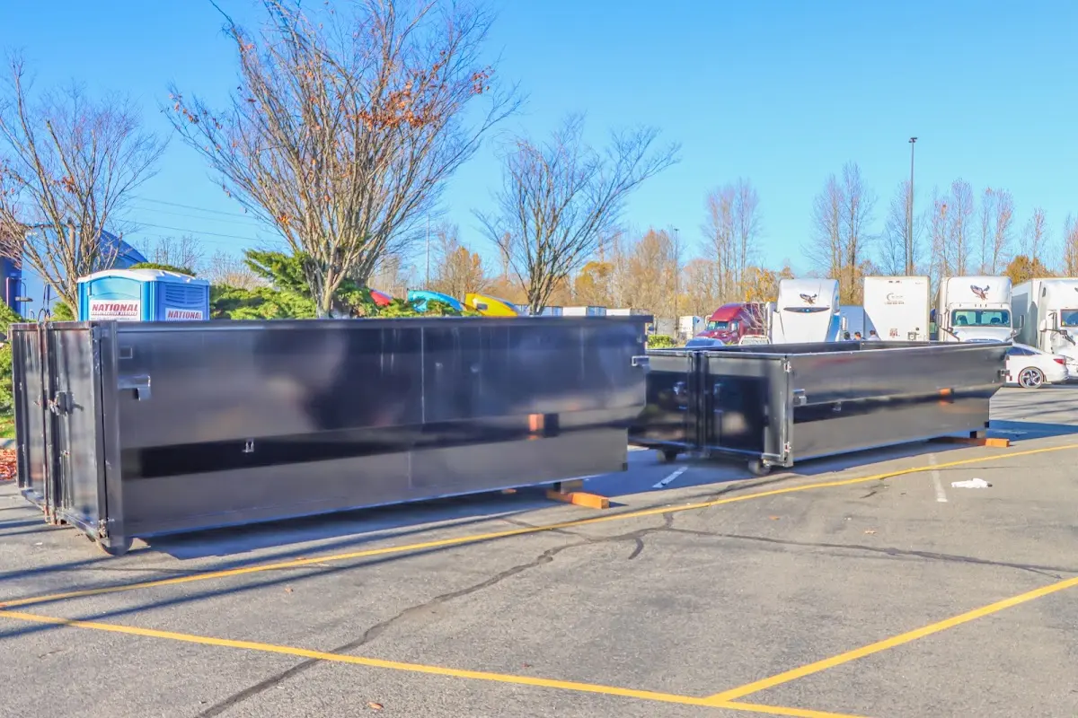 Professional dumpster rental service with roll-off container on residential driveway in Bullskin